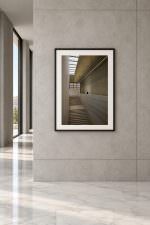 Room mockup: The photo in a black frame with white mat, on a grey stone wall beside tall windows and a marble floor.